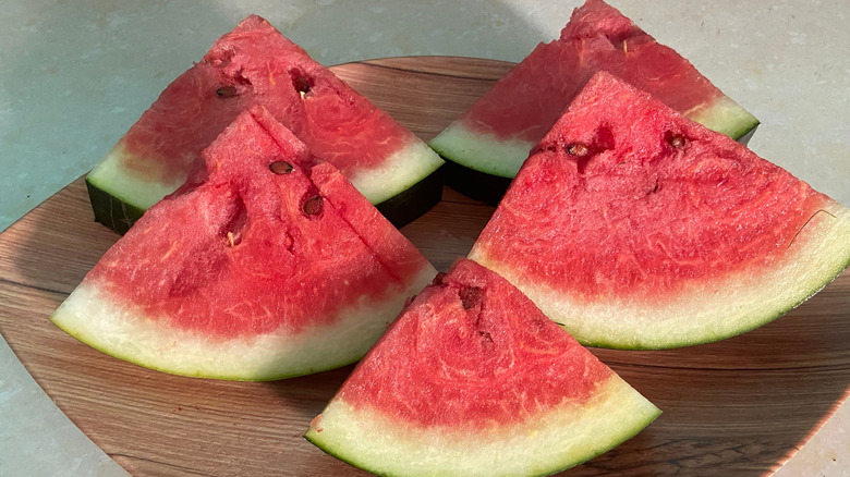 Watermelon wedges on a wooden plate