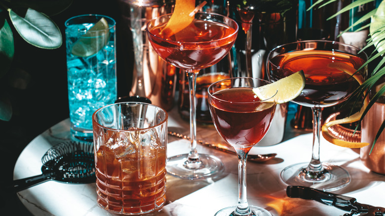 A selection of cocktails sit atop a bar