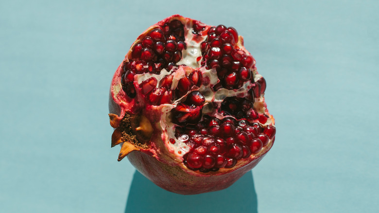 Split open pomegranate on blue background