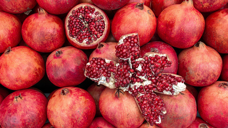 Open pomegranates on pile of pomegranates