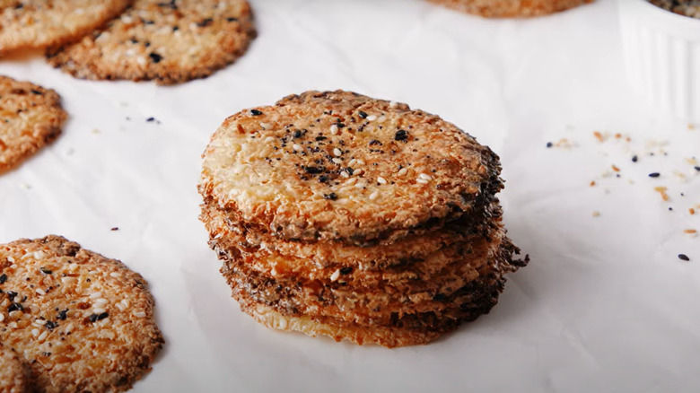 Pile of cottage cheese chips topped with sesame seeds