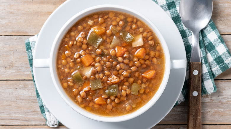Overhead view of lentil soup in a white bowl