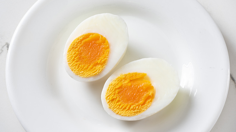 A plate of cut up hard boiled eggs.