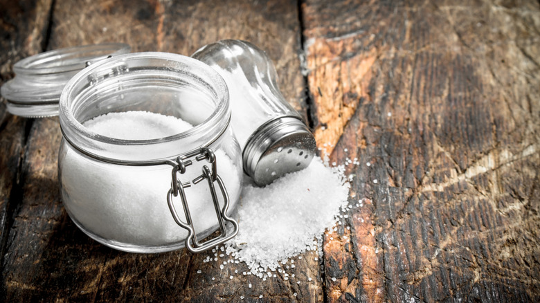 Two opened and spilled salt containers