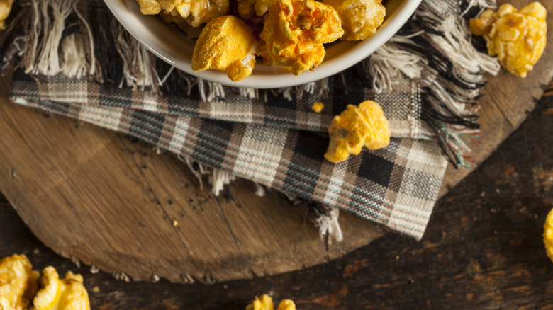 Overhead shot of cheddar and caramel popcorn in bowl