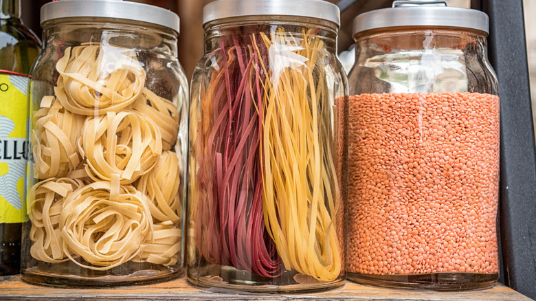 dried pasta and lentils in glass jars with lids