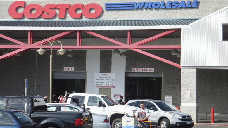The entrance to a Costco with cars and people