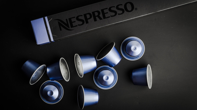 Assorted Nespresso pods alongside black Nespresso box