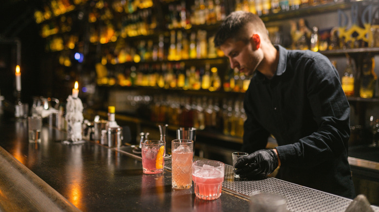 A bartender making cocktails.