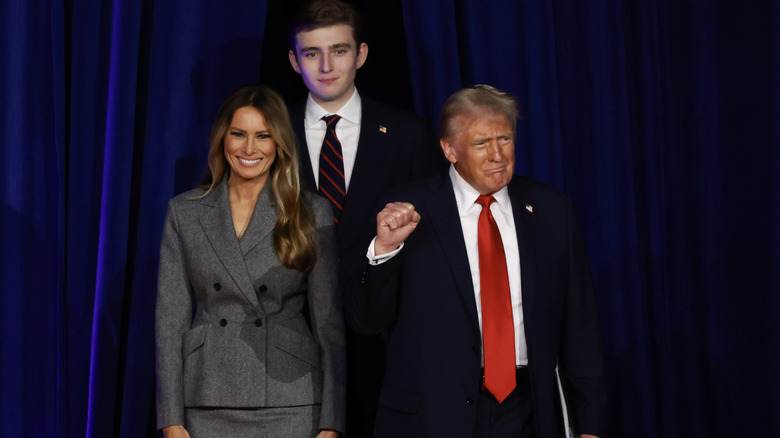 Melania and Donald Trump with their son Barron behind them