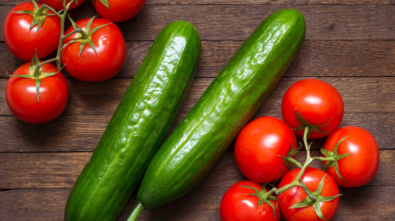 Tomatoes and cucumbers on a wooden table