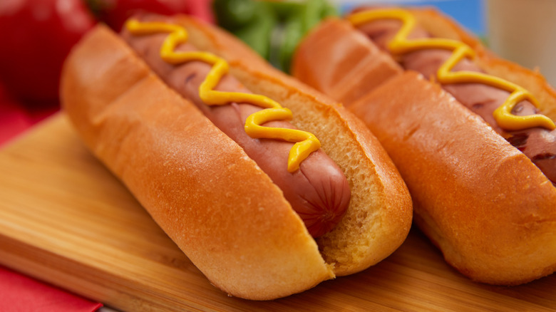 Two hot dogs with mustard