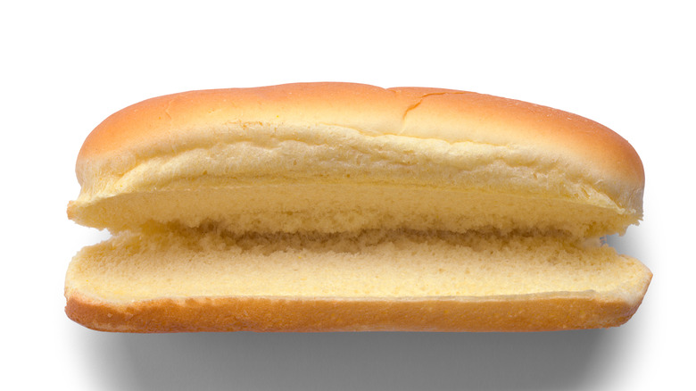 A split hot dog bun on a white background