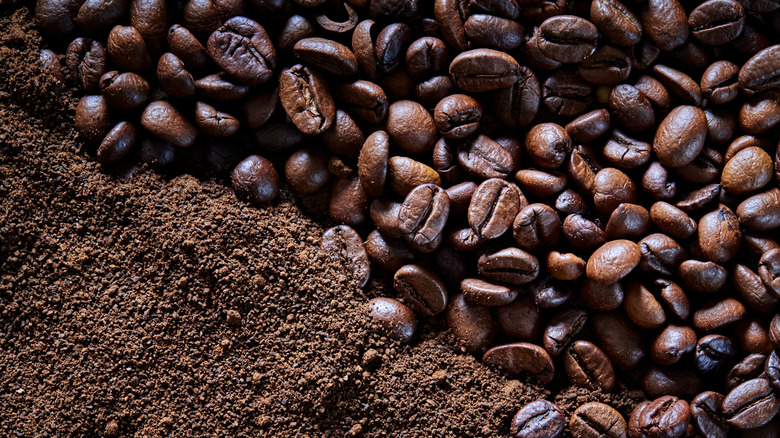 A variety of roasted coffee beans with ground coffee