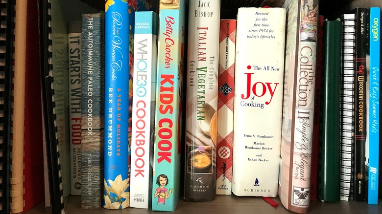 A collection of cookbooks on a shelf