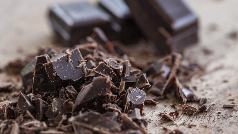 A close-up shot of a crumbled dark chocolate bar.
