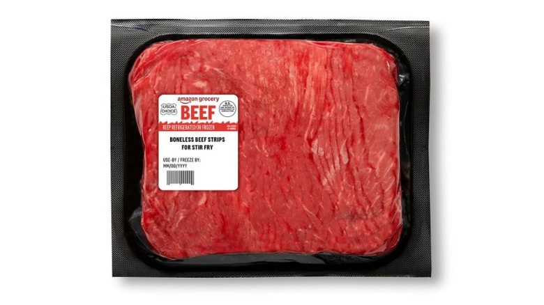 A pack of Amazon Grocery Beef Strips on a white background