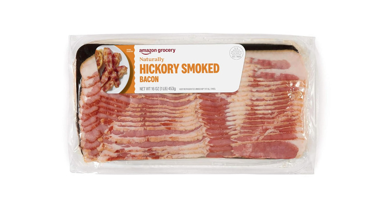 A package of Naturally Hickory Smoked Bacon from Amazon Grocery on white background