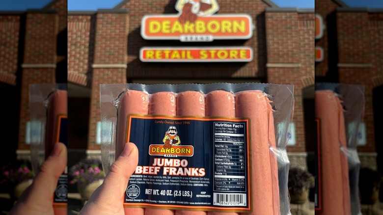 Hand holding package of Dearborn jumbo beef franks