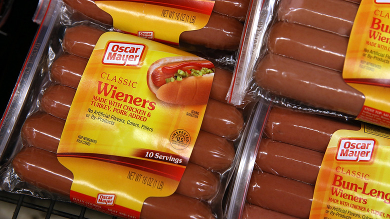 Packages of Oscar Mayer classic wieners in rows at a store