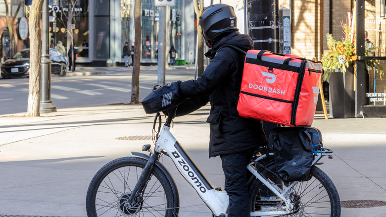 DoorDash delivery person on a rental ebike