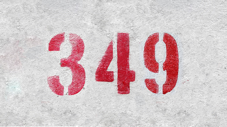 The number 349 spray painted in red on a wall