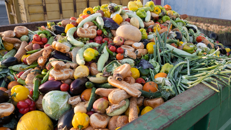 A waste bin overflowing with unsold produce
