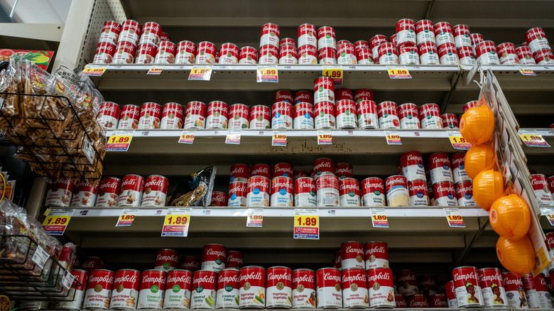 Rows of Campbell's soup cans on shelves at a Kroger grocery store