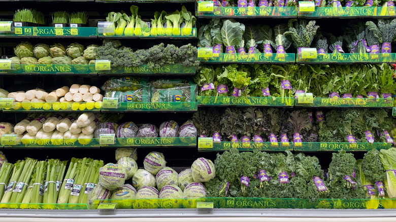 A full display of green organic vegetables inside a Safeway store