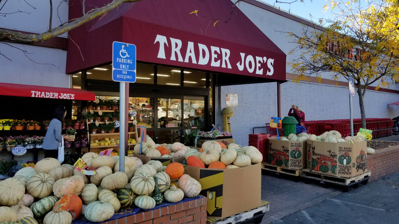 Bins of pumpkins outside a Trader Joe's grocery store