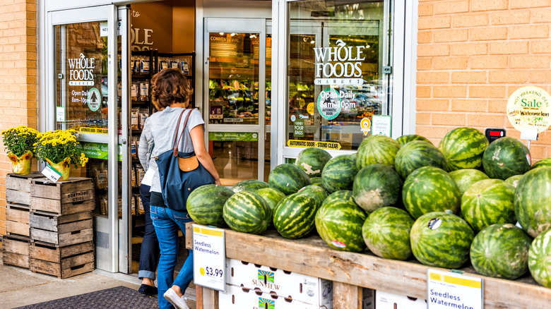 Stacked watermelons for sale outside the entrance to Whole Foods Market