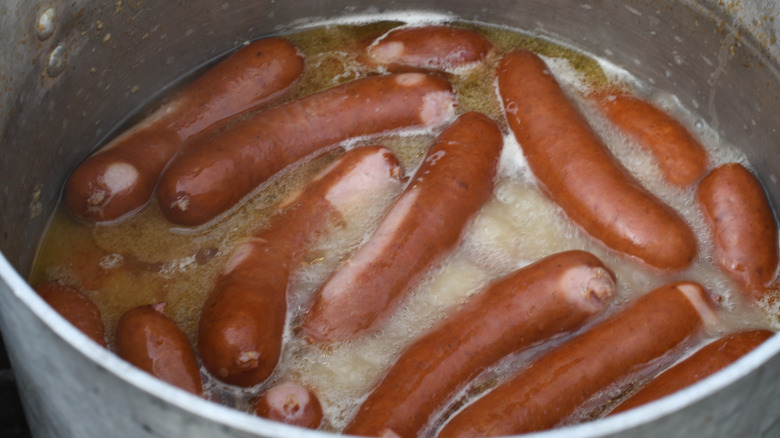 Bratwurst sausages boiling in a bot of beer