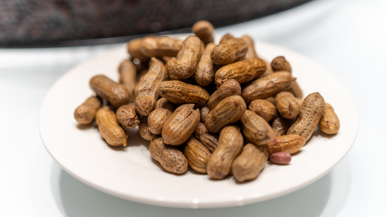 A plate of boiled peanuts, still in their browned and softened shells.