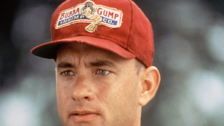 Movie still of Forrest Gump in Bubba Gumb Shrimp Co. red baseball cap