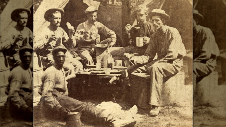 Civil War soldiers having a meal with coffee at camp