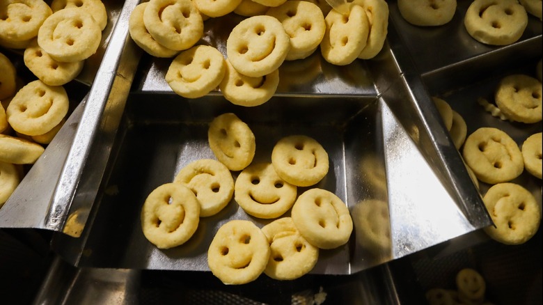 Metal factory trays containing Smiles smiley fries
