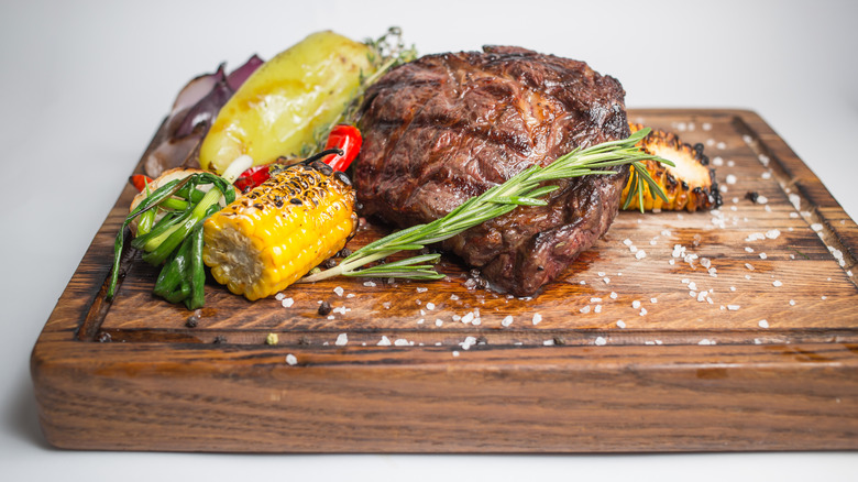 Well-done steak on a wooden board