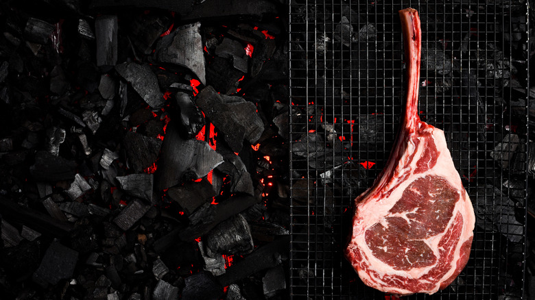 Steak cooked on grill over hot coals