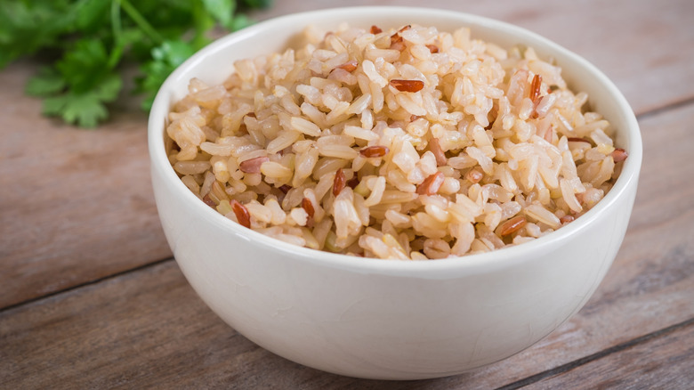 Cooked brown rice in a white bowl
