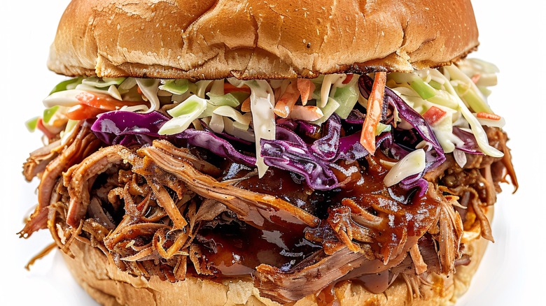 Close-up of a barbecue pulled pork sandwich topped with coleslaw