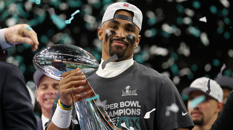 Philadelphia Eagles Quarterback Jalen Hurts holding the Super Bowl LIX trophy after his team's victory