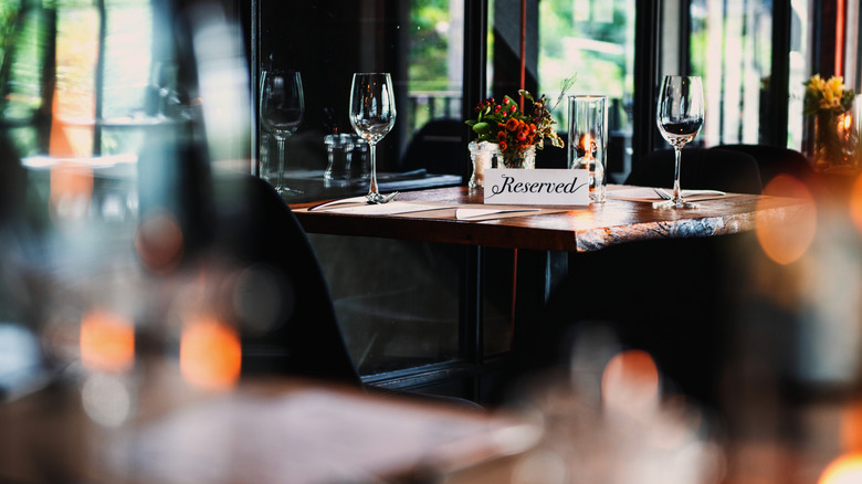 restaurant table with "reserved" sign