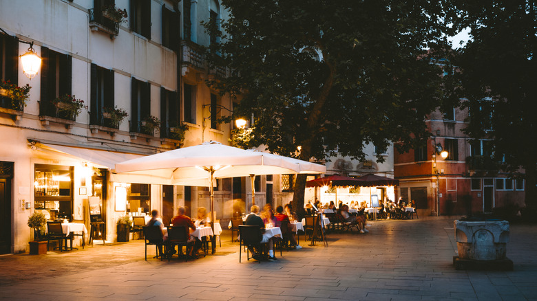 View of an Italian restaurant patio from the plaza