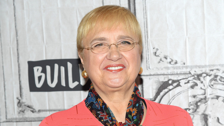 Lidia Bastianich in coral blouse and colorful scarf