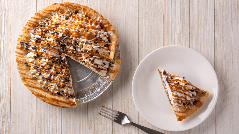A slice of pie next to the whole pie that it came rom