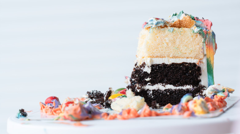 A slice of leftover multicoloured frosted cake