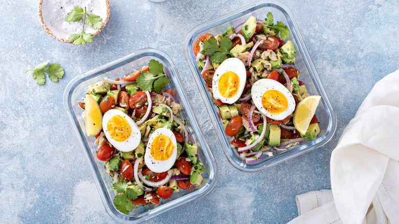Tuna salad with eggs and avocados in glass containers