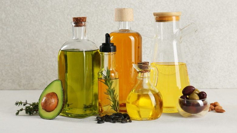 A variety of bottled oils together including olive oil, avocado oil, and sunflower oil