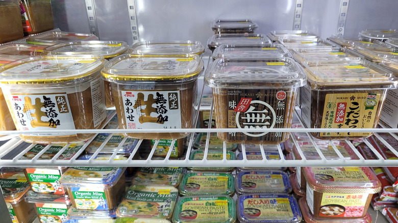 Tubs of miso in a supermarket fridge