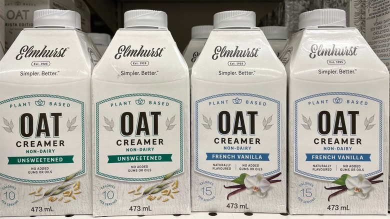Containers of non-dairy oat creamer on store shelf